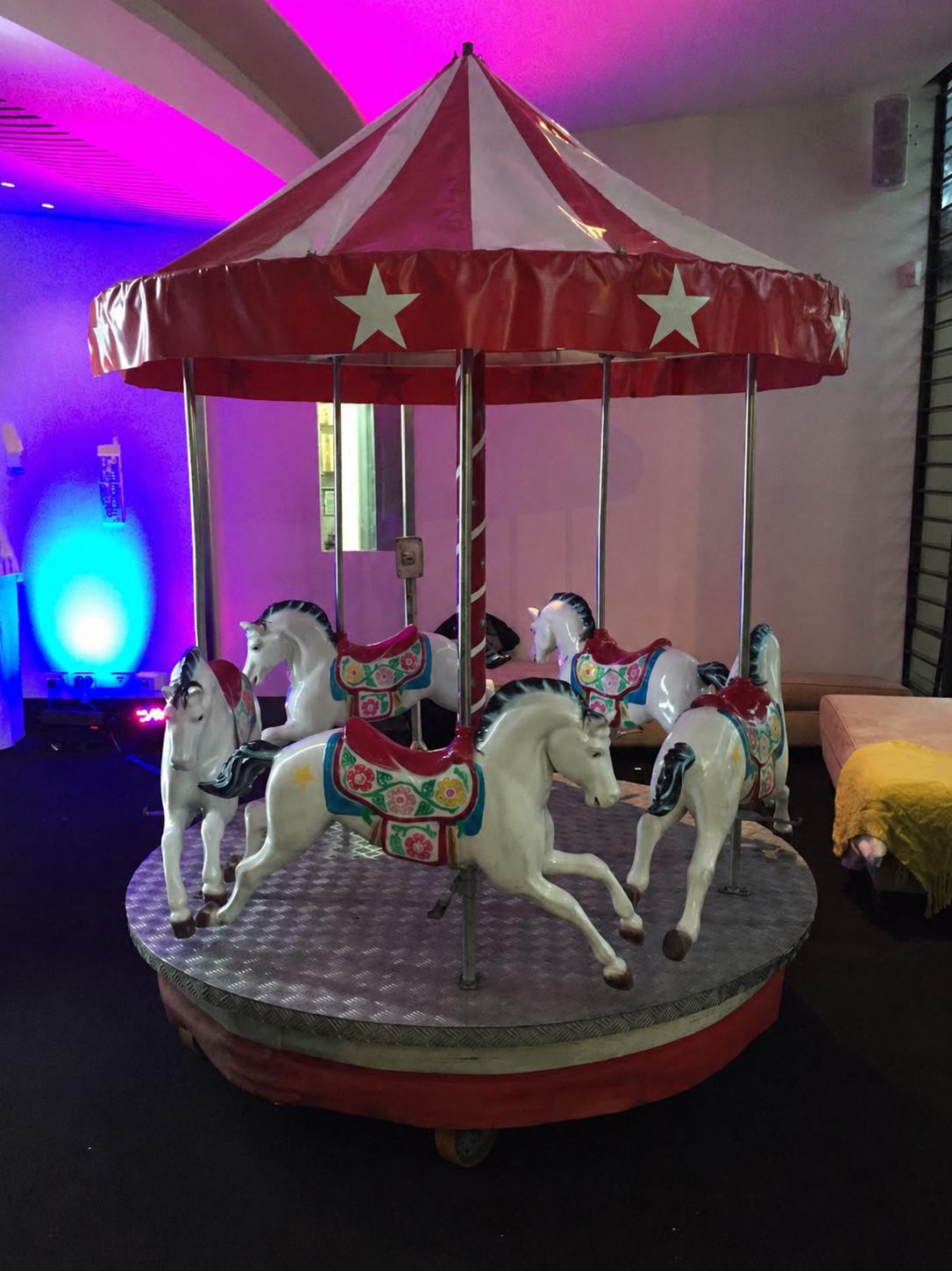 Mini carousel hire setup indoors for a children's party