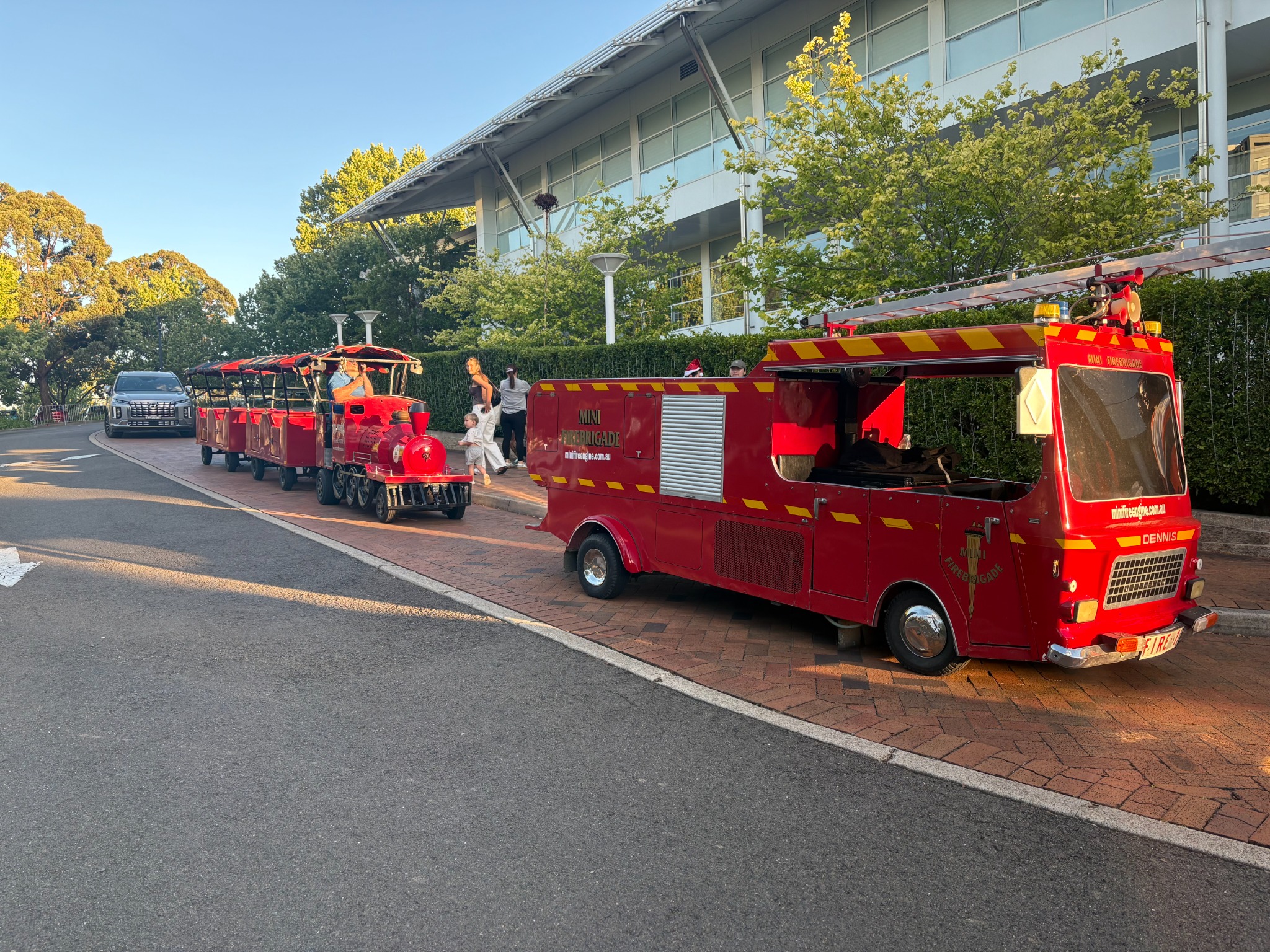 Mini fire engine and trackless train together at a family event