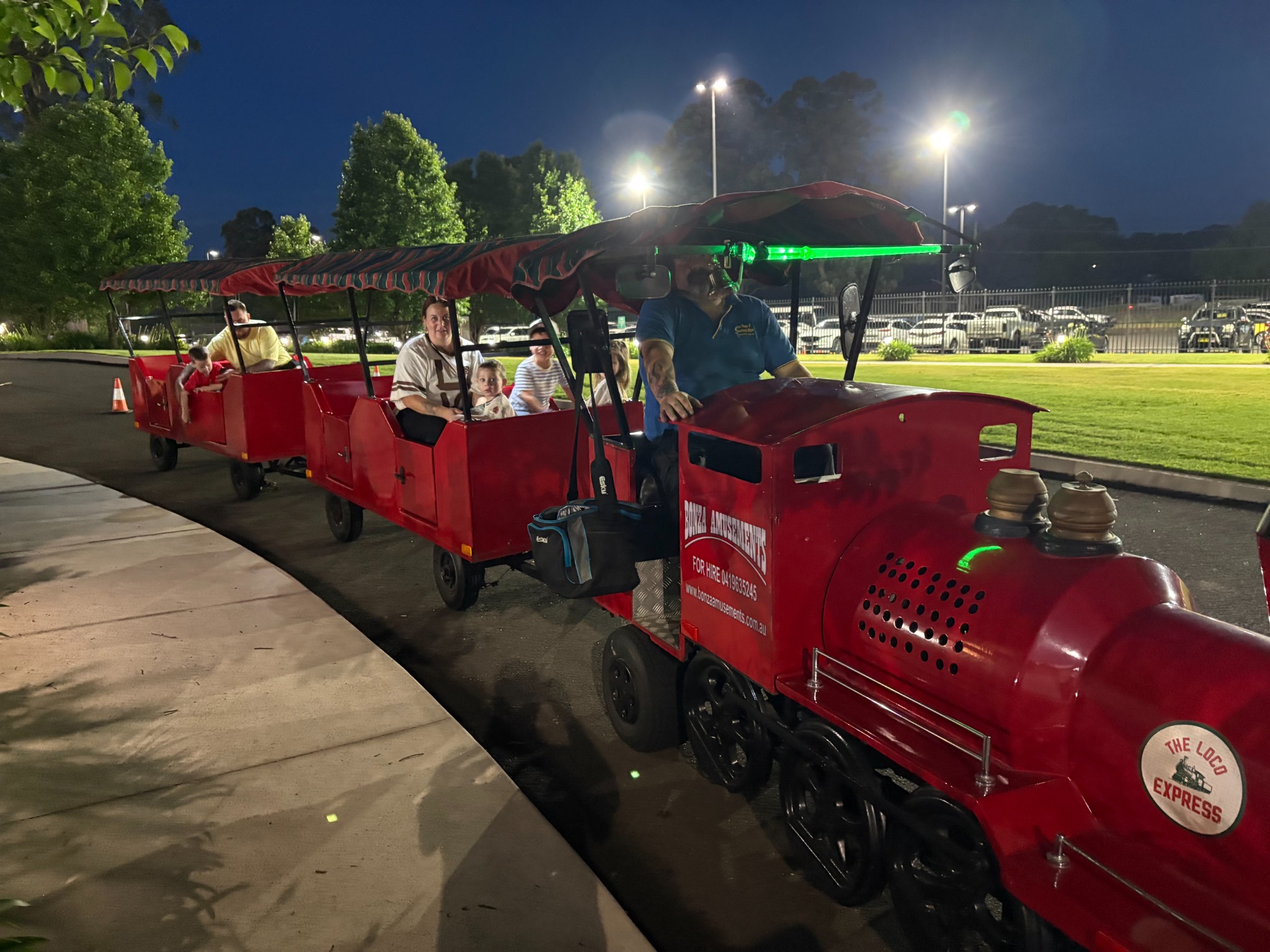 Trackless train with families at a night event